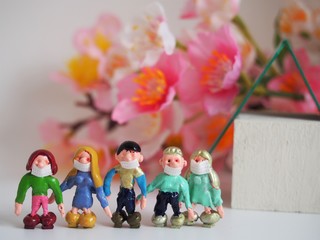 Obraz na płótnie Canvas Children wearing masks (flower, house) Landscape photo of miniature figurine.