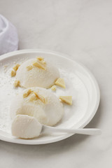 Delicious italian dessert panna cotta with milk chocolate on a plate on white background