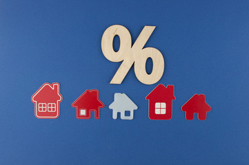 Top view. Model house with wooden sign percent. Mortgage and interest on the house. buy of...