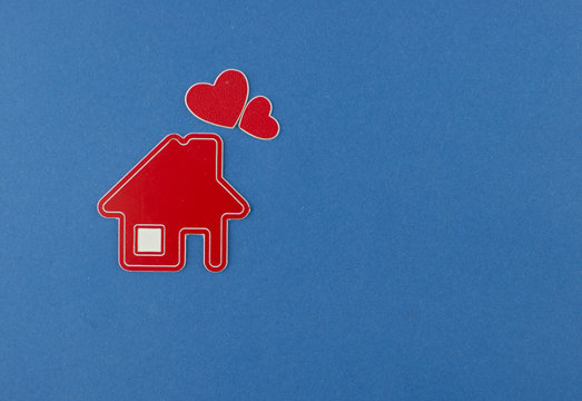 Miniature house on blue background. Top view.
