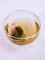 tea in a transparent glass, on a white background