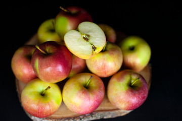Fresh harvest of red apples on a black background, farm organic fruits