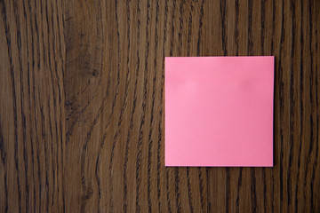 Colorful sticky notes on wooden background image.