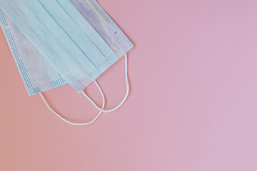 Blue surgical masks on a pink background. Covid-19 - Wuhan New Coronavirus Pneumonia. Protective...