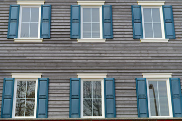 Fototapeta na wymiar residential windows facade blue gray wood planks home building