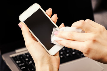 Smartphone screen cleaning with a microfiber wipe and antiseptic liquid