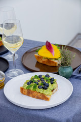 avocado tost with blackberries and mango, and some wine