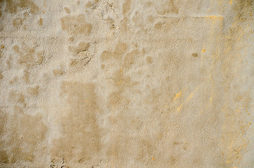 gray wall of old house closeup. White and yellow  peeling plaster. Cracks on the surface of building or fence. City building concept. Copy space. Place for text. Selective focus image.
