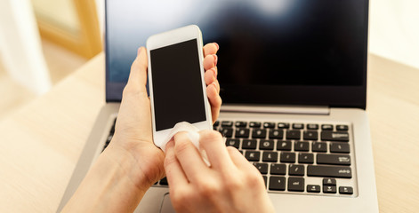 Smartphone screen cleaning with a microfiber wipe and antiseptic liquid