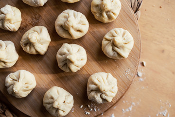 Fototapeta na wymiar Dumplings on a wooden plate