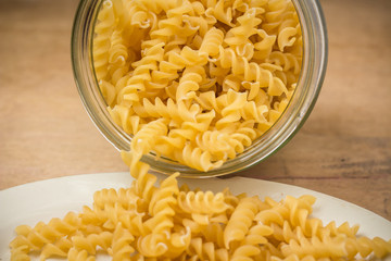 ringlet noodles in a glass jar and plate - macro