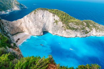 Navagio beach from top at Zakynthos island, Greece. Stranded shipwreck in unique beautiful blue bay surrounded by limestone mountain walls