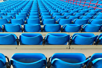 empty bleachers and chairs in blue