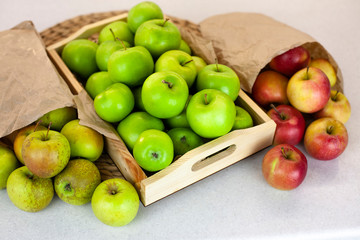 Different types of apples on a market table. Fresh harvest of red and green apples, farm organic fruits