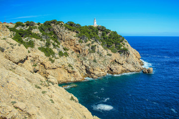 Fototapeta na wymiar Faro de Capdepera lighthouse on top of cliffs in Cala Gat near Cala Rajada, Mallorca, Spain