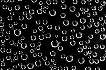 Air balls in water on a black background