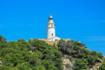 Fototapeta na wymiar Faro de Capdepera lighthouse on top of cliffs in Cala Gat near Cala Rajada, Mallorca, Spain