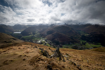 Snow covered summits of the Helvellyn Range above Patterdale, from the descent of Place Fell, Lake District, UK