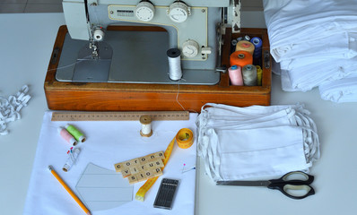 Homemade medical mask in the process. Sewing virus face mask at home. Letter CORONAVIRUS STOP.