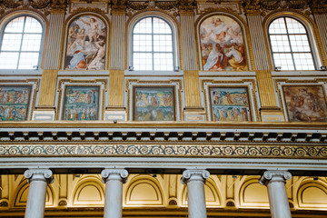 Fototapeta premium Rich ornate corridor of church, golden decoration of the ceiling and walls.