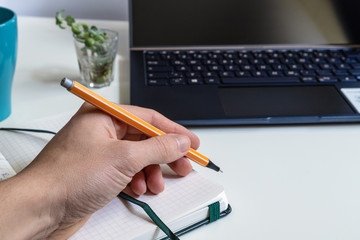 Man working on laptop, close up hands