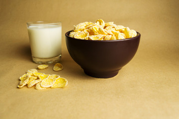 Flakes in a clay bowl and a glass of milk