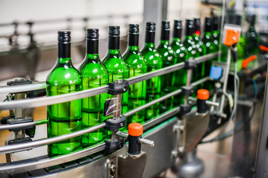 Bottling And Conveyor Line Or Belt At Winery Factory, Wine Bottles Filling Production.