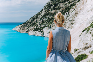 Women tourist enjoying Myrtos Beach. Travel vocation concept. Kefalonia, Ionian Sea, Greece