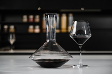 glass of red wine on a white table