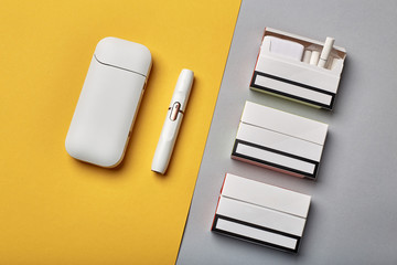 Electronic Cigarette Technology. Tobacco IQOS system. Close-up an electric hybrid cigarette with a...