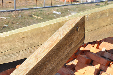 Close-up on the roof framing, installation of two end trusses.