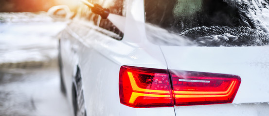 Car Wash Business detail. Washing luxury Car with Copy Space. Wide banner or panorama picture.