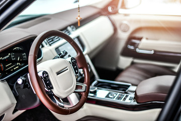 Interior view of car, Luxury car steering wheel and clean dashboard with display or monitor screen.