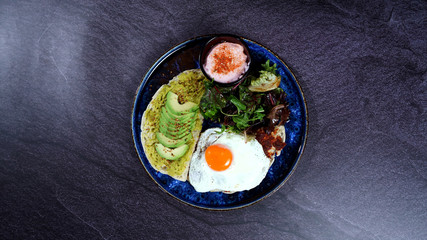 Avocado egg, tomato sauce and fresh salad