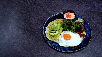 Avocado egg, tomato sauce and fresh salad
