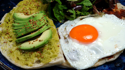 Avocado egg, tomato sauce and fresh salad