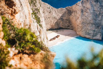 Famous shipwreck on Navagio beach. Blue sea cove surrounded by huge white limestone cliffs. Famous...