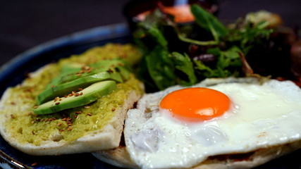 Avocado egg, tomato sauce and fresh salad