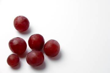 Red grape berries on a white background