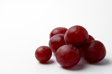 Red grape berries on a white background