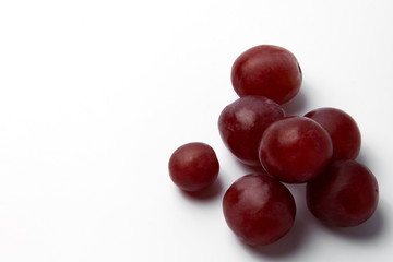 Red grape berries on a white background