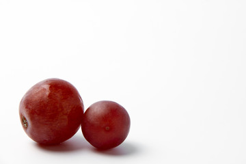 Red grape berries on a white background