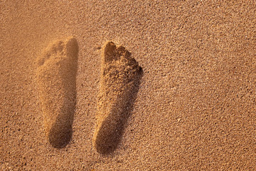 Two human footprints in the sand