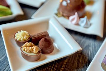 Plate of candy and a few plates with cakes
