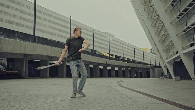 handsome fighter sword dancing on street