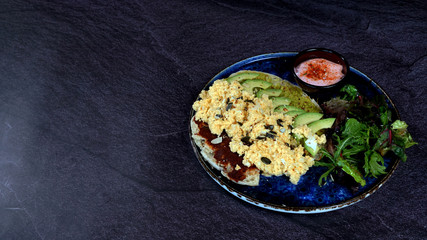 Avocado egg, tomato sauce and fresh salad