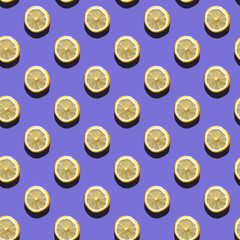 Slices of lemon seamless pattern on purple background, natural sunlight with hard shadows. Healthy eating concept