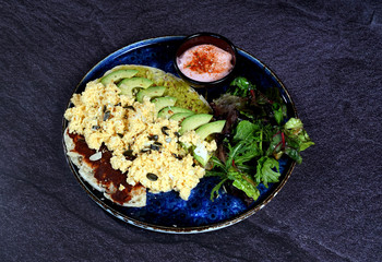 Avocado egg, tomato sauce and fresh salad