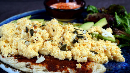 Avocado egg, tomato sauce and fresh salad