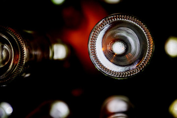 White bottoms of wine bottles illuminated by bright light